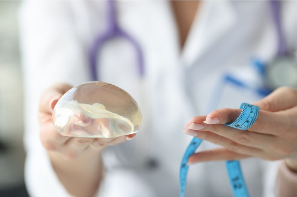 doctor holding breast implant