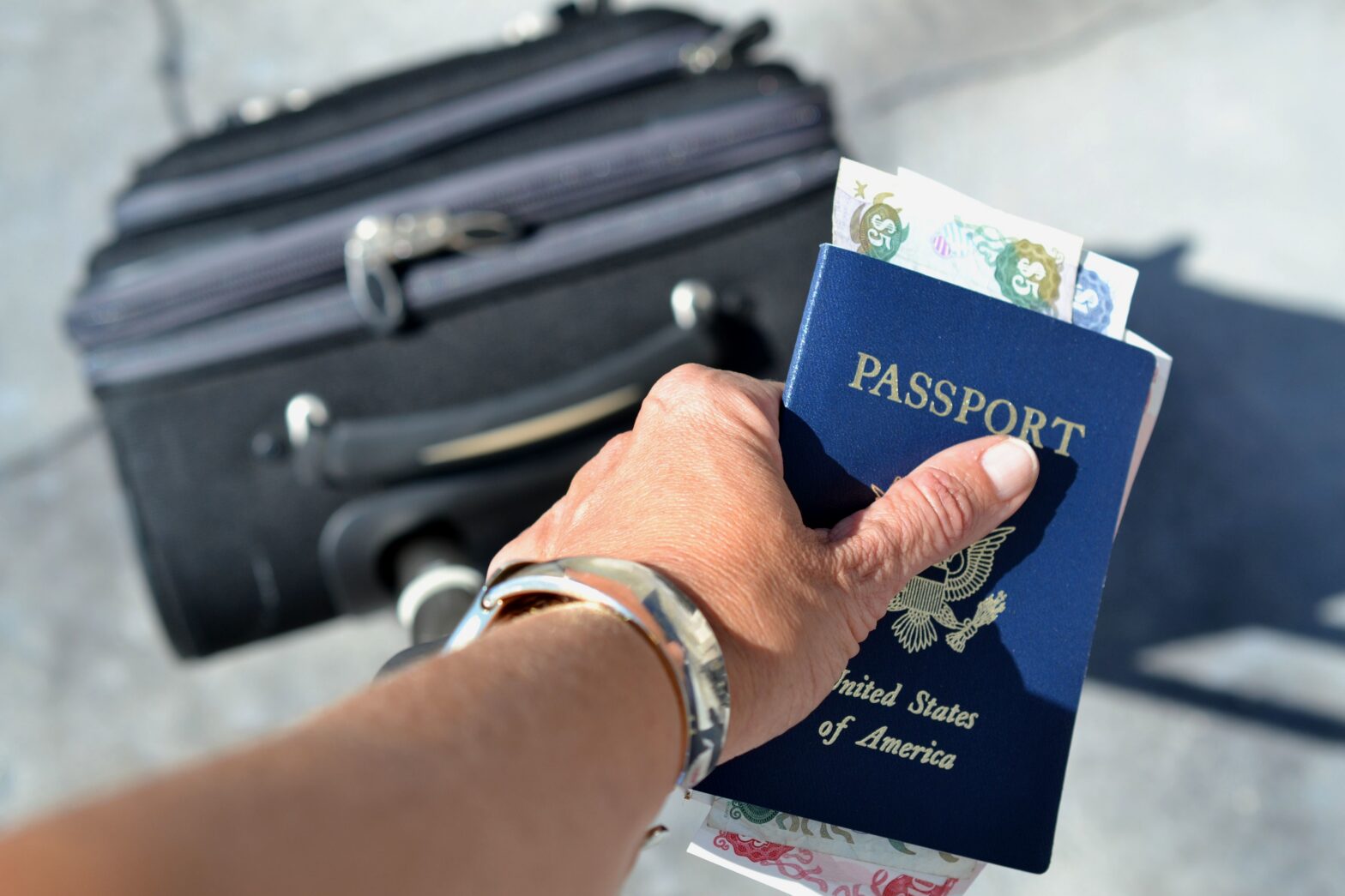 Woman holding passport and luggage