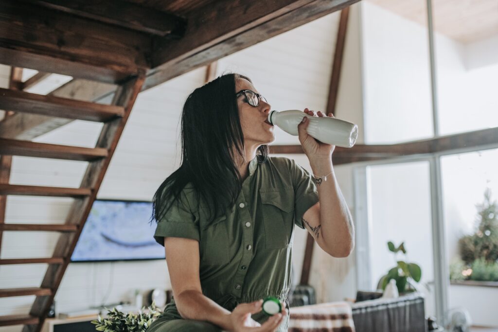 Woman drinking from water bottle
